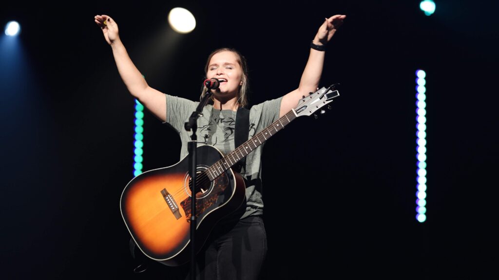 Female Worship Leader - Abby leading worship on a Sunday morning
