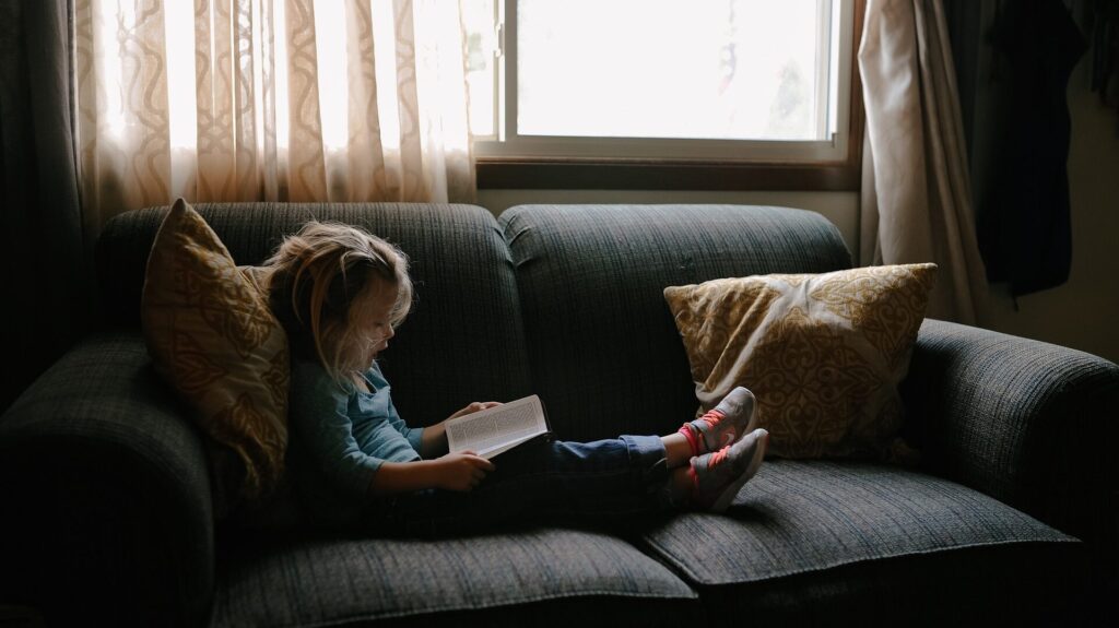 Kid reading the Bible - Questions to ask your kids about worship