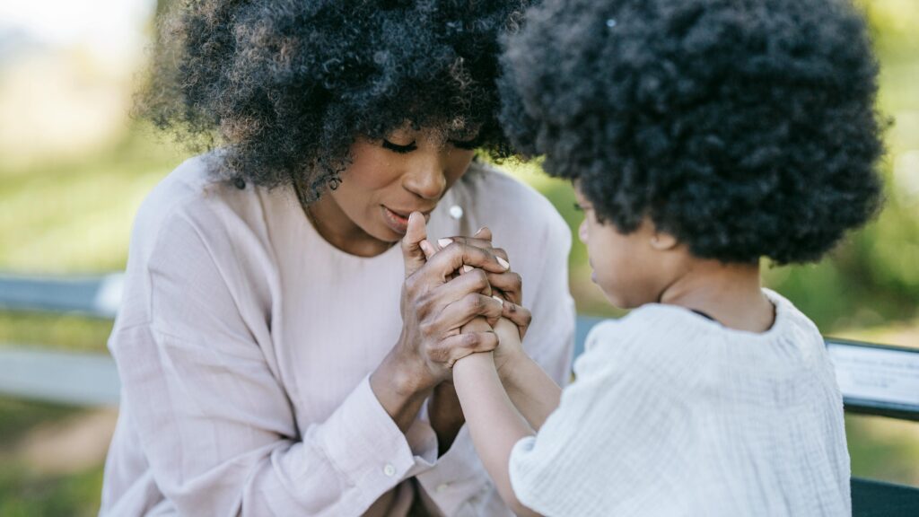 Mom and daughter praying - learning to worship at home